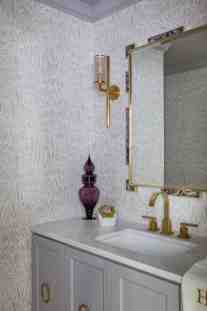 The soft plums and purples mixed with gold hardware in Powder Bath by ML Interiors Group in Dallas, Tx.