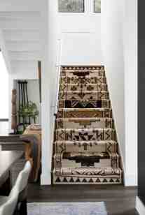 A tribal runner with rich shades of caramel, brown and linen warm this very contemporary white staircase.