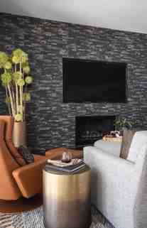 A vibrant caramel recliner adds the pop of color to this subtle brown color palette. The warm antique brass of the side table provides a hint of sheen to the matte finishes of the rug and sofa.