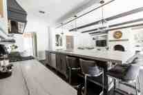 Kitchen interior design with eat-in kitchen island seating and lighting by ML Interiors Group in Dallas, TX